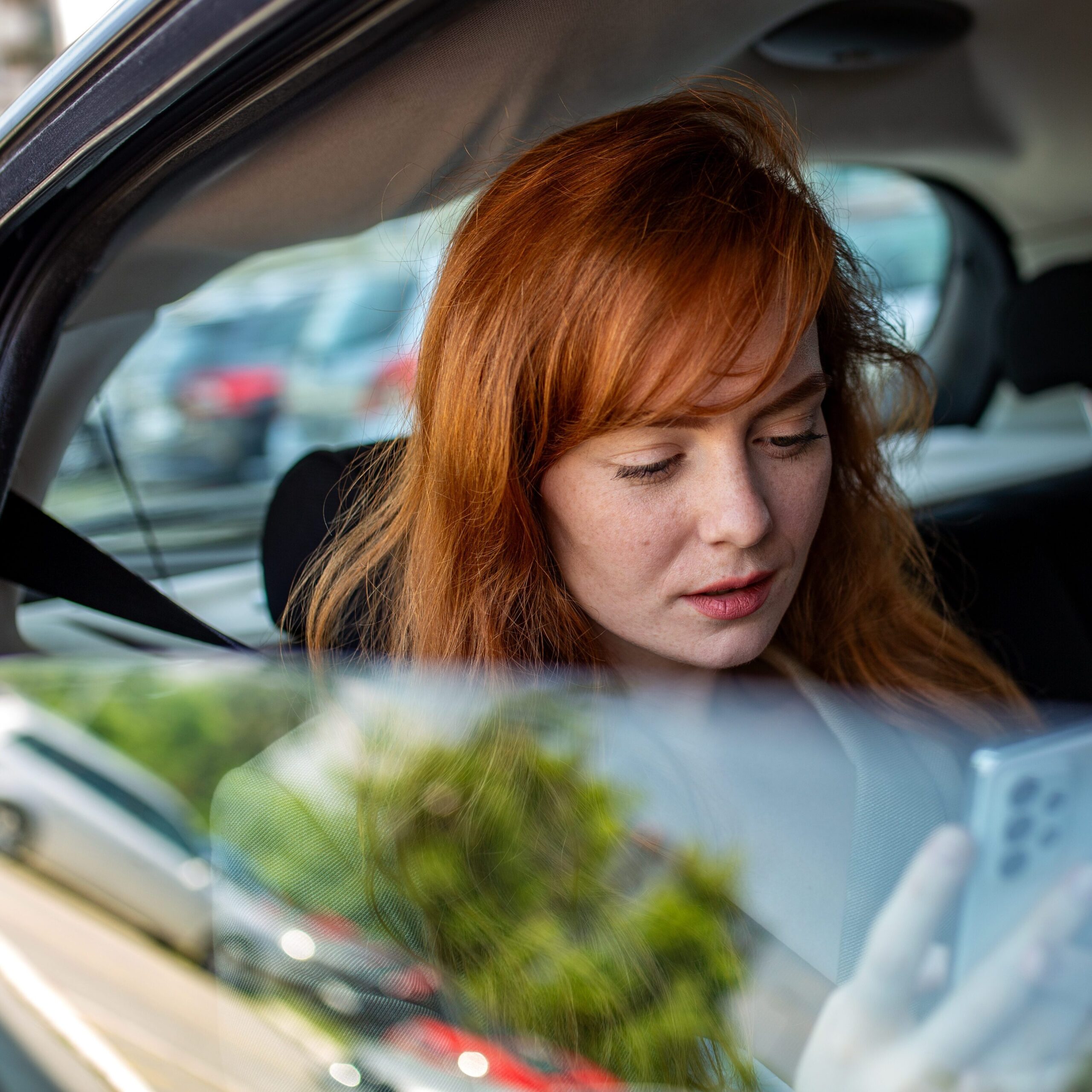 female passenger looking at phone screen